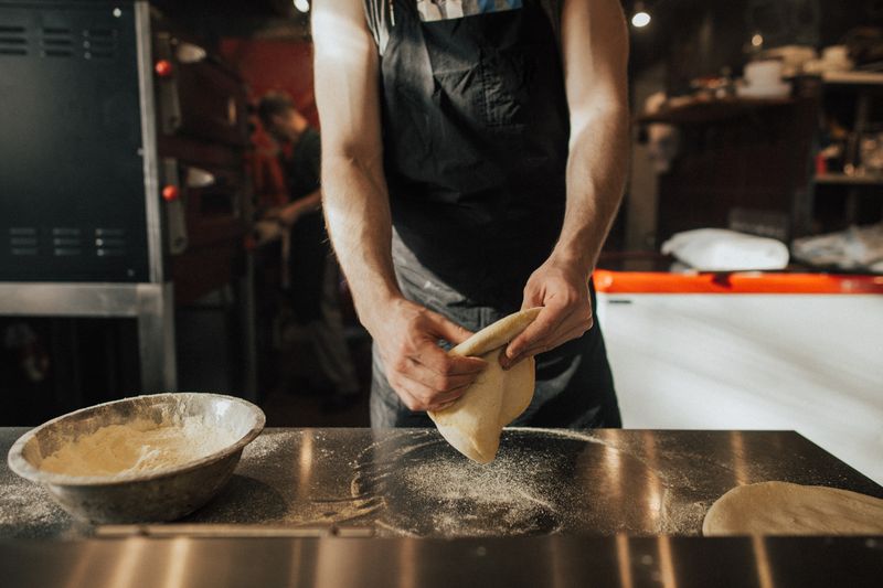 Via 313 kitchen team preparing Detroit-style pizza dough